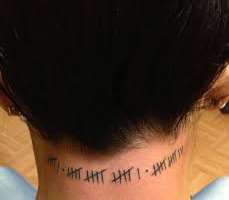 She bears a tally mark tattoo on her neck, which reads the numbers 6,16 and 13 She bears a tally mark tattoo on her neck, which reads the numbers 6,16 and 13.